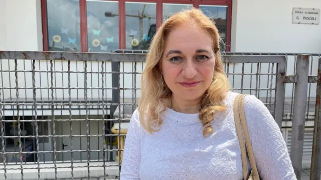 Headteacher Luana Scarfi, a woman in a white top with blonde hair