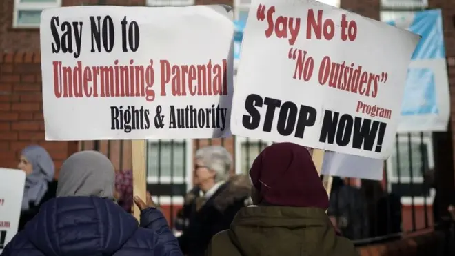 Messages on placards at the rally include "say no to undermining parental rights and authority".