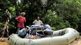 Porter Yusofu and Sakpa (right) load Will's packraft `Shostakovich' before setting out down the Moro River