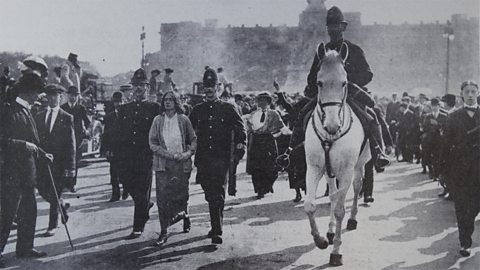 Suffragette Dora Thewlis being arrested by two policemen. 
