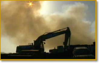 Smoke from a foot-and-mouth pyre billows out over a farm