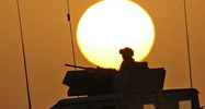 Angry Iraqis hit a bust of Saddam Hussein