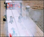 Two cars race along the 20 metre track