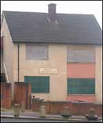 Boarded up house