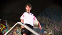 Nuala Ní Ágáin wearing County Derry kit with background graffiti.