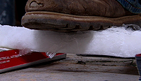 Jem's foot rests on a bar of cotton wool pykrete