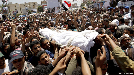 Yemeni anti-government protesters carry the body of a comrade who was among 52 people killed by security forces in a violent crackdown last week