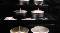 The teal-light candles are staggered on steps using DVD covers