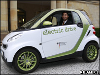 Germany's Economy Minister Philipp Roesler poses in an electric car